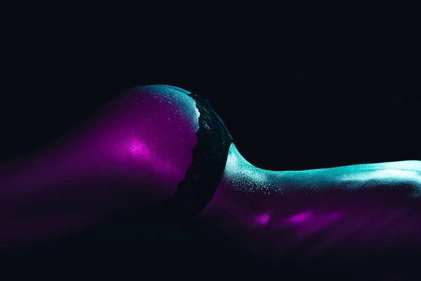 Sexy ass of a girl in panties with water drops on her body close-up. Silhouette of a sporty slim female body - Фото, зображення