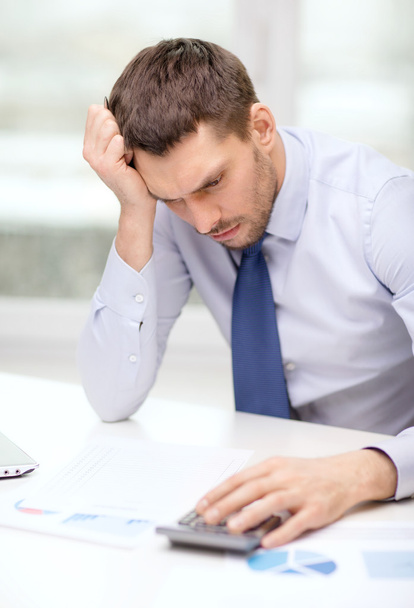 stressed businessman with laptop and documents - Photo, image