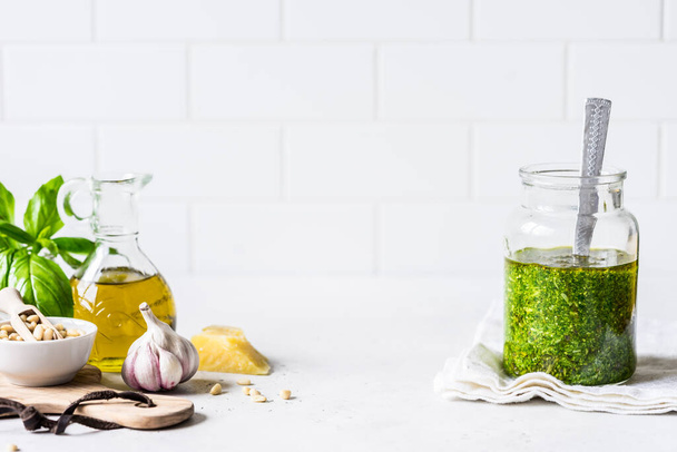 Pesto Sauce with  Ingredients: Fresh Basil, Pine Nuts, Olive Oil and Cheese, copy space for your text - 写真・画像
