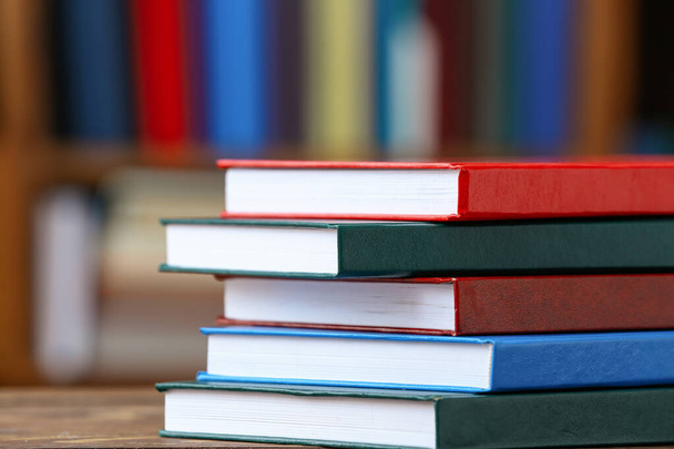 Stack of books on table in library - Photo, Image