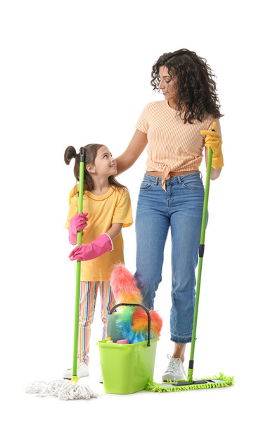Mother and daughter with cleaning supplies on white background - Фото, изображение