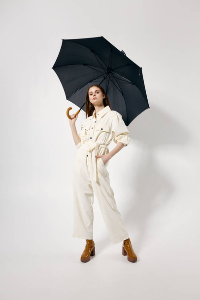 pretty woman open umbrella white suit fashion modern style isolated background - Foto, imagen
