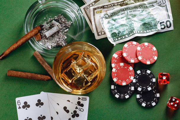 Glass of whiskey, cigar, playing cards and chips on green background - Zdjęcie, obraz