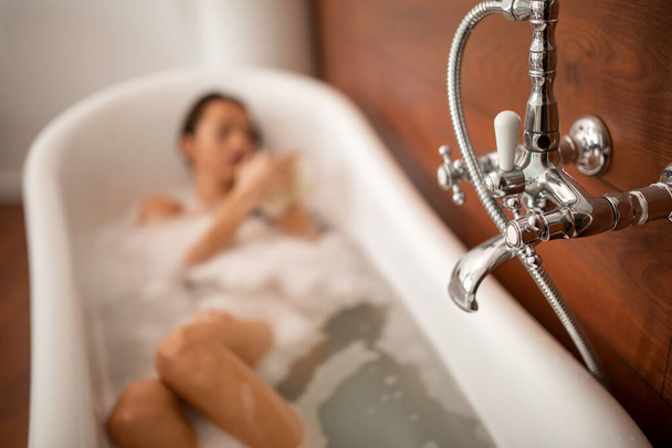 Beautiful sensual woman relaxing in bathtub. Wellness, spa, beauty concept. - Fotó, kép