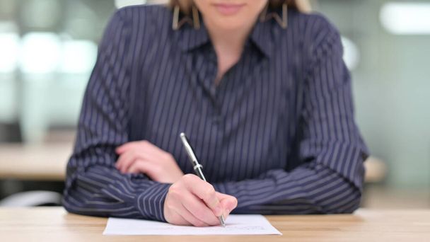 Close up of Businesswoman Writing on Paper - Photo, Image