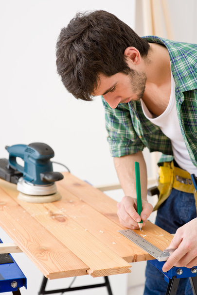 Home improvement - handyman prepare wooden floor in workshop - Foto, immagini
