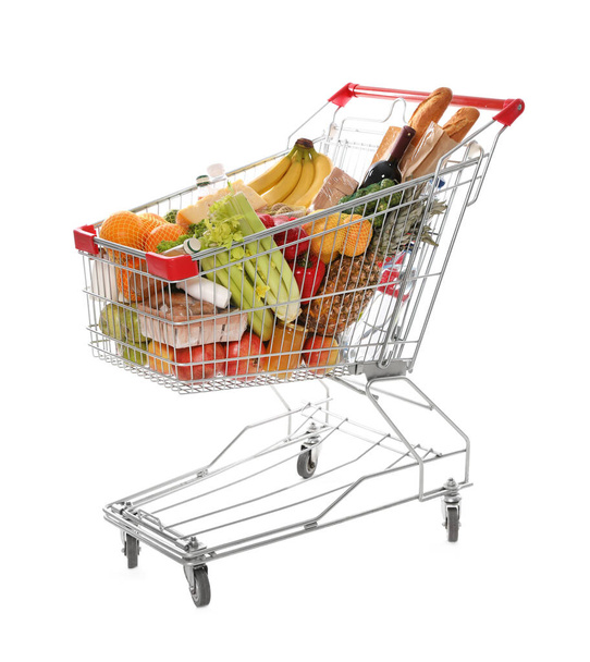 Shopping cart full of groceries on white background - Foto, imagen