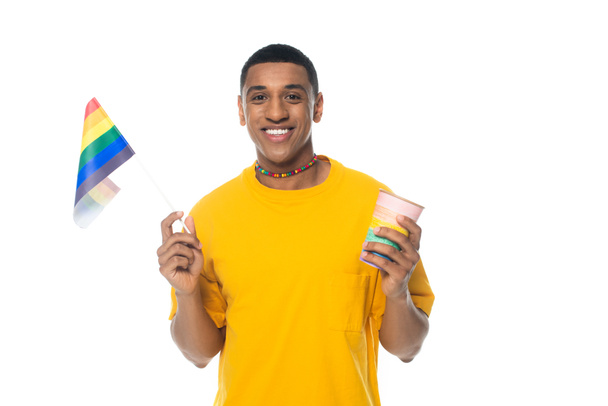 cheerful african american man holding coffee to go and lgbt flag isolated on white - Фото, зображення