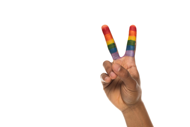 partial view of african american man showing peace sign with fingers painted in rainbow colors isolated on white, lgbt concept - Foto, Imagem