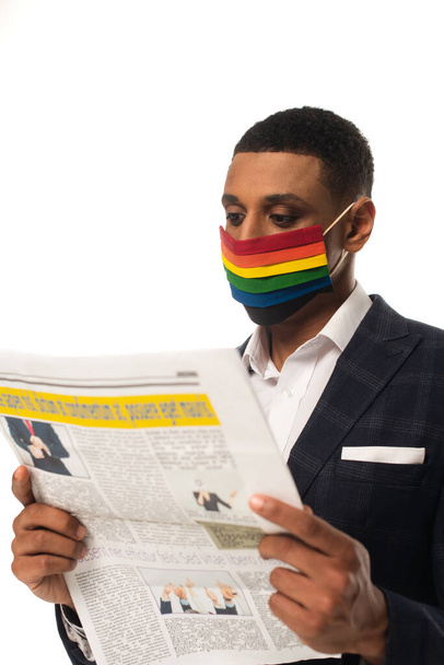 african american homosexual businessman in lgbt colors protective mask reading news isolated on white - Photo, Image