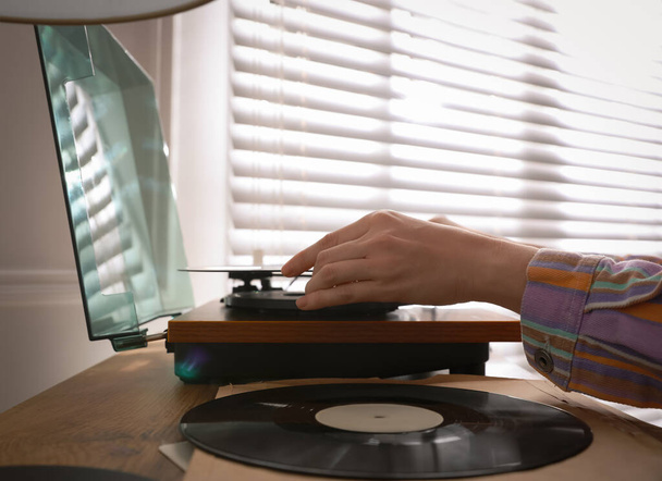 Young woman using turntable at home, closeup - Фото, зображення