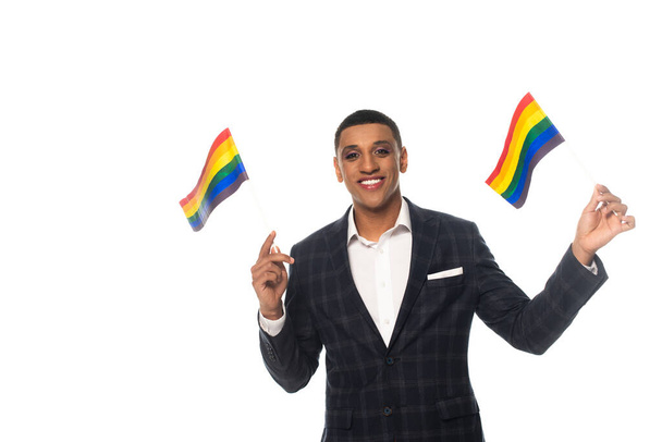 happy african american businessman with makeup holding lgbt flags isolated on white - Photo, Image