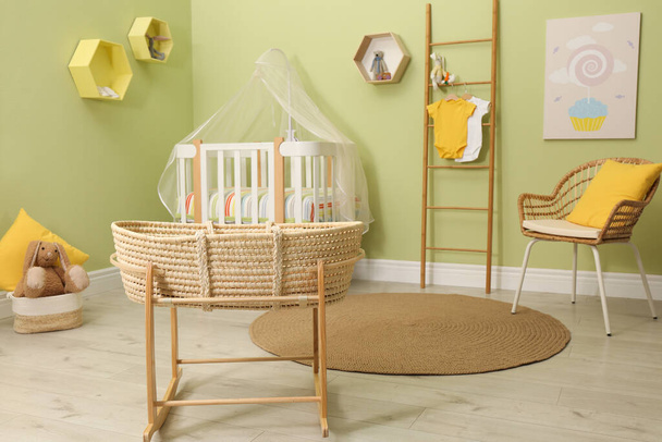 Baby room interior with stylish furniture and wicker cradle - Zdjęcie, obraz
