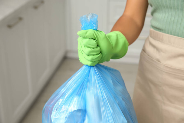 Woman holding full garbage bag at home, closeup - Zdjęcie, obraz