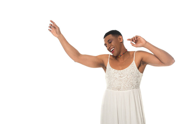 happy african american transsexual man in sundress dancing with closed eyes isolated on white - Foto, imagen
