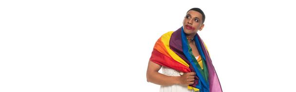 african american transsexual man, covered with lgbt flag, looking way isolated on white, banner - Photo, Image