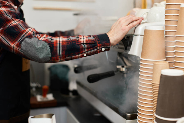 Barista using a coffee machine to make coffee - Foto, Imagen
