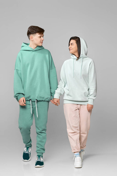 young couple wearing mint green casual hoodie - Valokuva, kuva