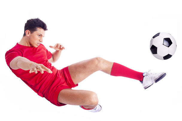 Soccer player making an acrobatic kick, isolated on white background - Foto, Imagem