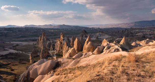 A magical sunset in the valleys of Cappadocia with quaint cliffs and mountains in Turkey - Fotó, kép