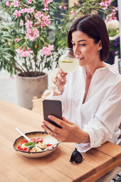Woman Making Video Call And Drinking Cocktail - 写真・画像