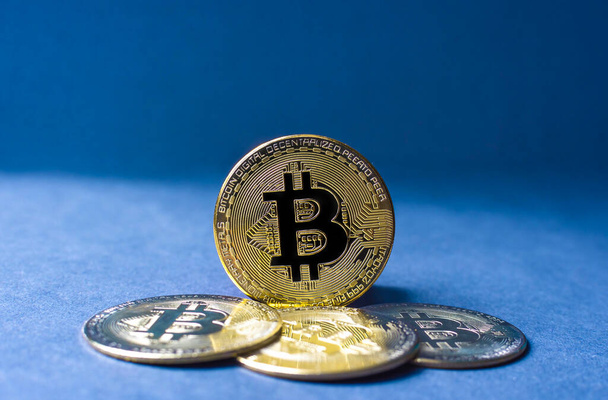Bitcoin BTC crypto valuta gouden munten op blauwe achtergrond, nieuwe virtuele geld concept. Mijnbouw of blockchain technologie - Foto, afbeelding