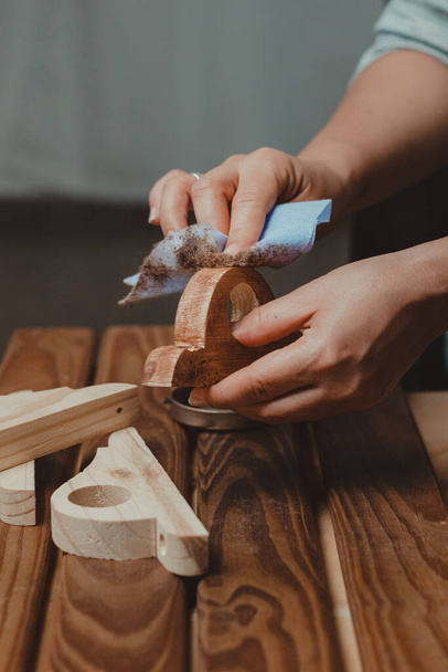 Woman's hands waxing wood. Action close up. Home carpentry concept. - Fotó, kép