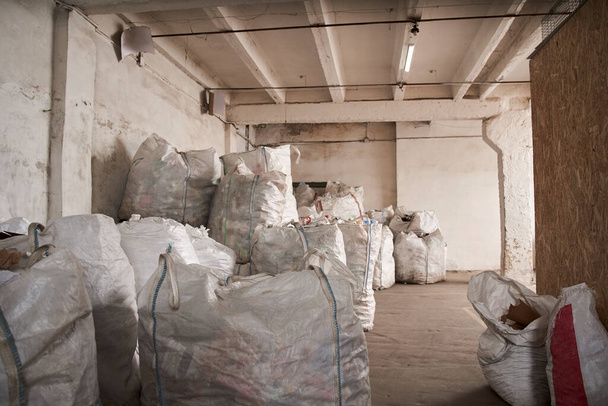 Bags with a sorting rubbish at the garbage sorting factory - Foto, Imagen