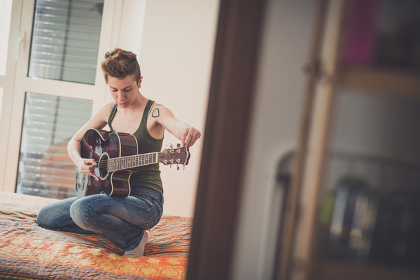 Lesbian  woman playing guitar - Photo, Image