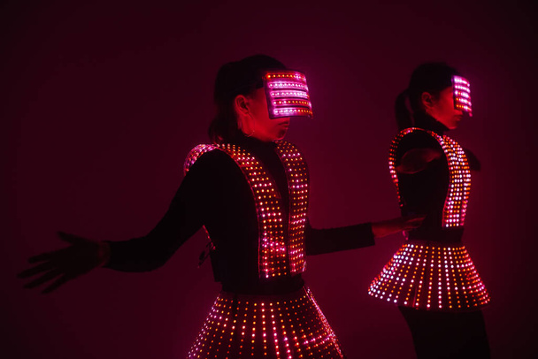 Two sexy disco dancers move in UV costumes. Parties and dances. - Fotoğraf, Görsel