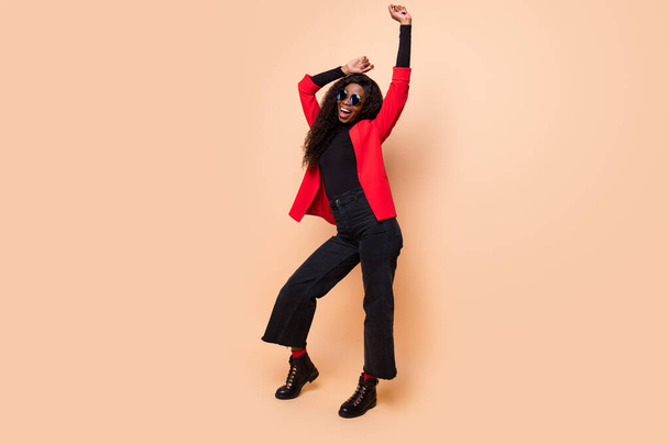 Full length photo of afro american charming lady raise hands smile dance isolated on beige color background - Photo, image