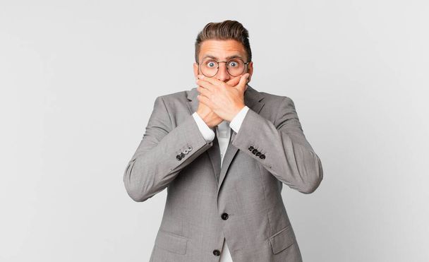 young handsome man covering mouth with hands with a shocked. business concept - Photo, image