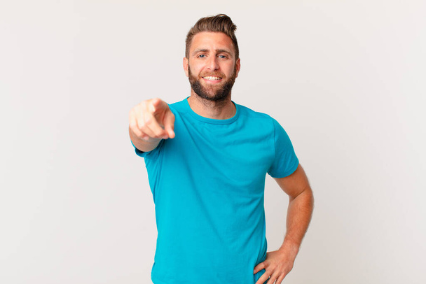 young handsome man pointing at camera choosing you. fitness concept - Foto, imagen