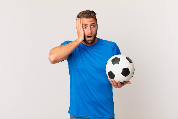 young handsome man feeling happy, excited and surprised. soccer concept - Фото, изображение
