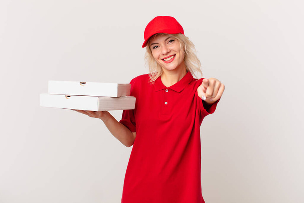young pretty woman pointing at camera choosing you. pizza delivering concept - Foto, afbeelding