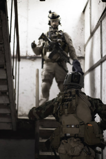 two guys in american military uniform stand on the stairs, airsoft sports game, military forces simulation - Photo, Image
