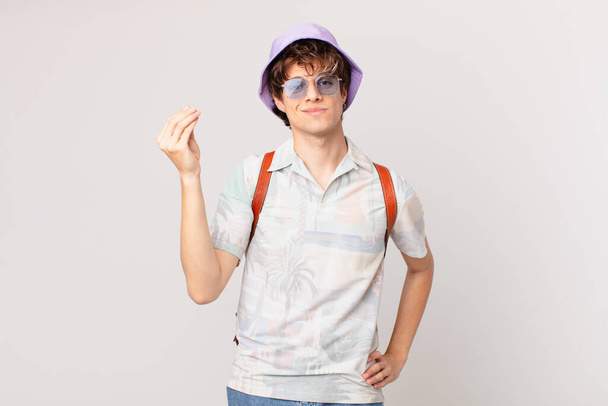 young traveller or tourist man making capice or money gesture, telling you to pay - Fotó, kép