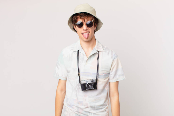 young traveller or tourist man feeling disgusted and irritated and tongue out - Foto, Imagen