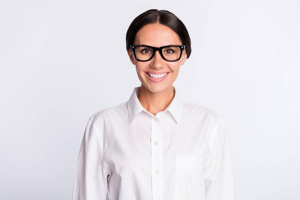 Photo of optimistic brunette hairdo lady wear spectacles white shirt isolated on grey color background - Foto, imagen