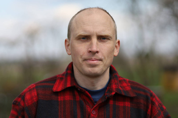 Confident middle-aged peasant man and plaid shirt - Photo, Image