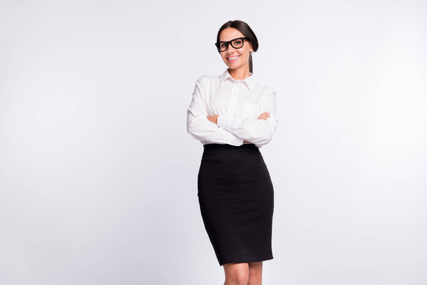 Photo of optimistic brunette hairdo lady stand crossed arms wear spectacles shirt skirt isolated on grey background - Foto, immagini