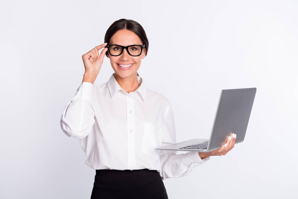 Photo of optimistic brunette hairdo lady hold laptop wear spectacles shirt isolated on grey color background - Photo, Image