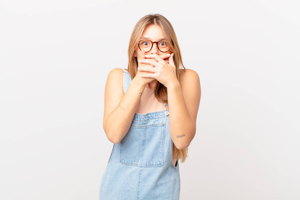 young pretty woman covering mouth with hands with a shocked - Fotoğraf, Görsel