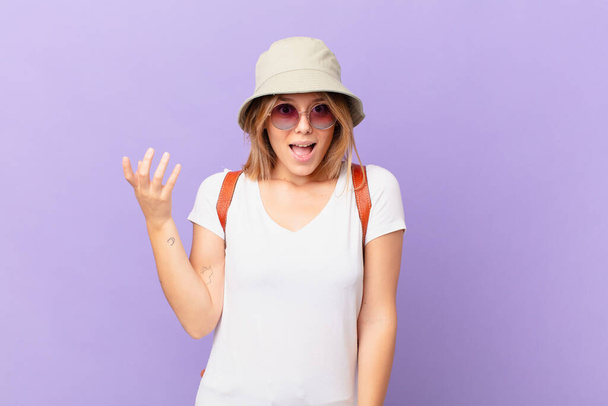 young traveller tourist woman feeling happy, surprised realizing a solution or idea - Fotó, kép