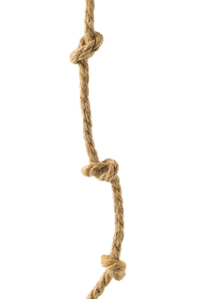 Rough rope with three knots isolated on a white background. Material for binding various products. - Photo, Image