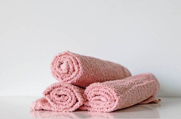 pastel pink bath towel rolls on shelf, selective focus - Photo, Image