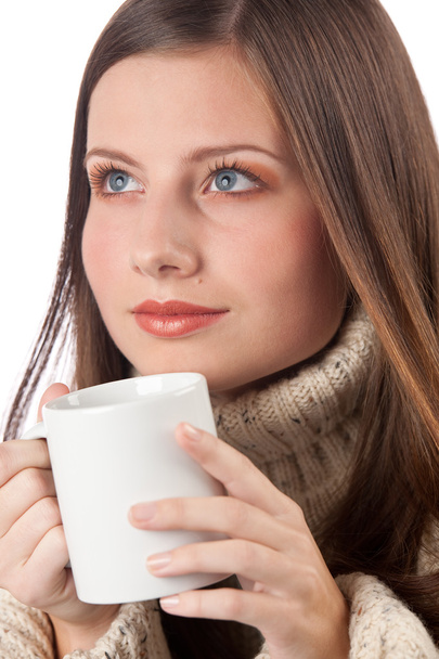 Winter portrait of happy woman holding cup of coffee wearing turtleneck on white - Zdjęcie, obraz