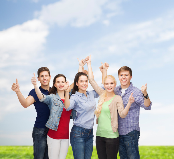 group of smiling students showing thumbs up - Photo, image