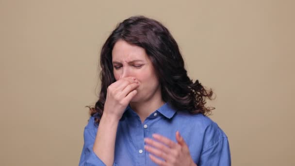 Αηδιαστική μυρωδιά: γυναίκα καλύπτουν τα χέρια κύμα μύτη για να αποφευχθεί η κακή μυρωδιά, κλανιά άρωμα, δύσοσμο αέριο. Φωτογραφία στούντιο - Πλάνα, βίντεο