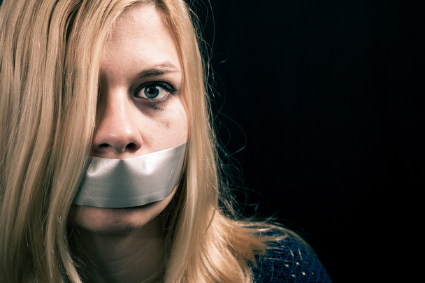 Kidnapped woman hostage with tape over her mouth - Fotografie, Obrázek
